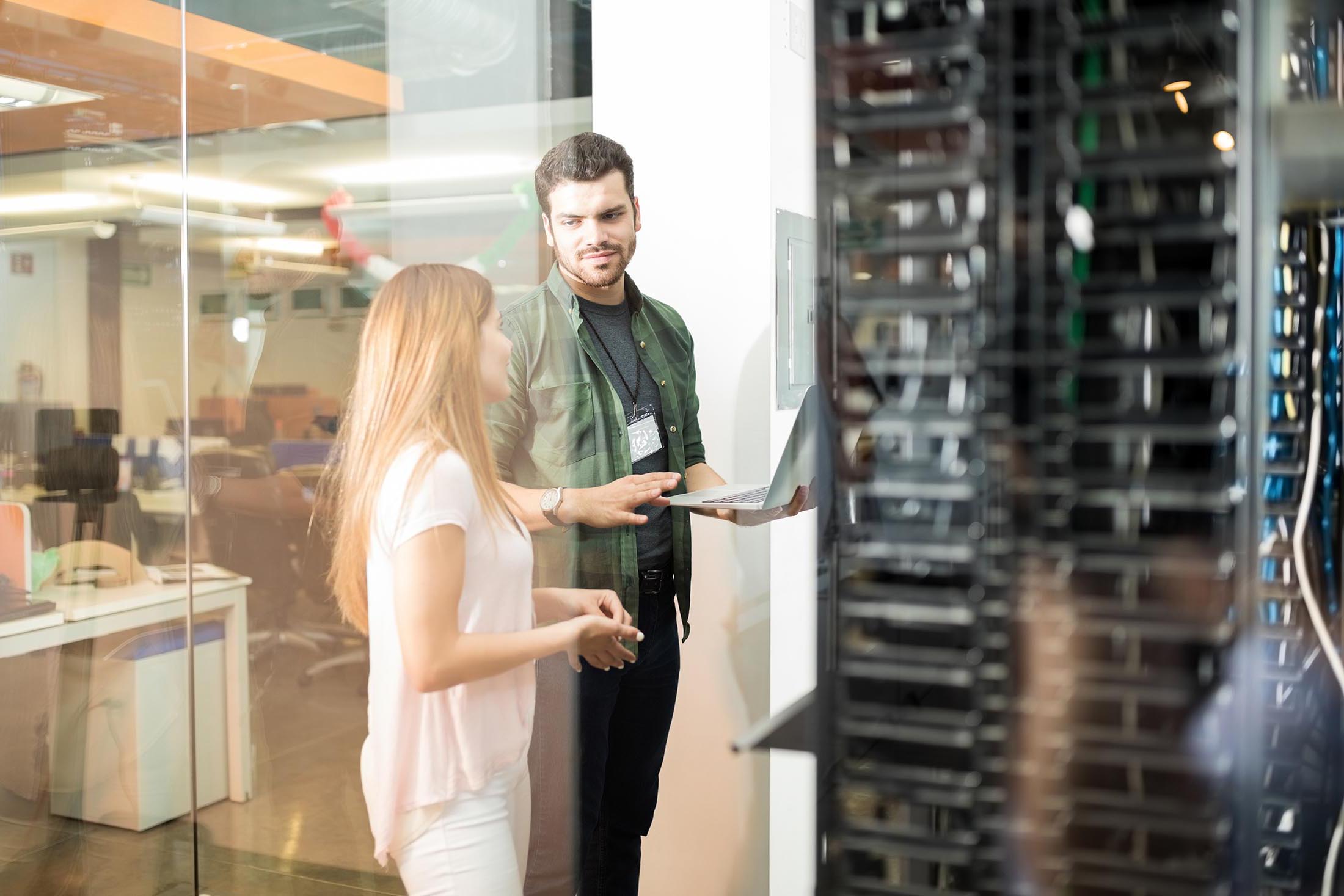 Colleagues discussing in office server room